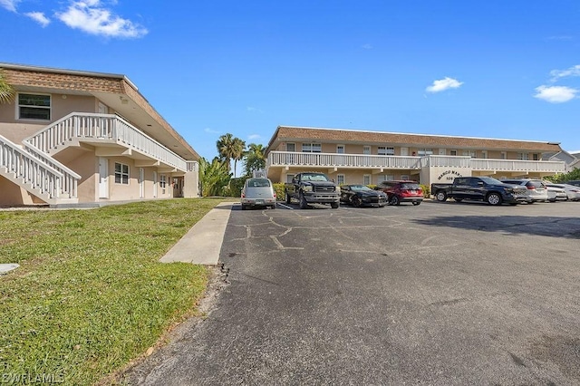 view of vehicle parking featuring a yard