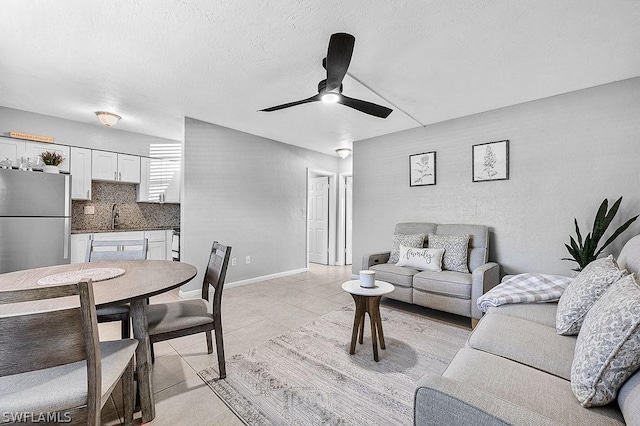 living room featuring light tile patterned floors and ceiling fan