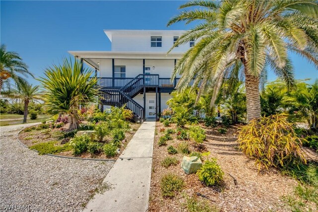 rear view of property with covered porch