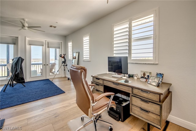 home office featuring ceiling fan, light hardwood / wood-style floors, and french doors