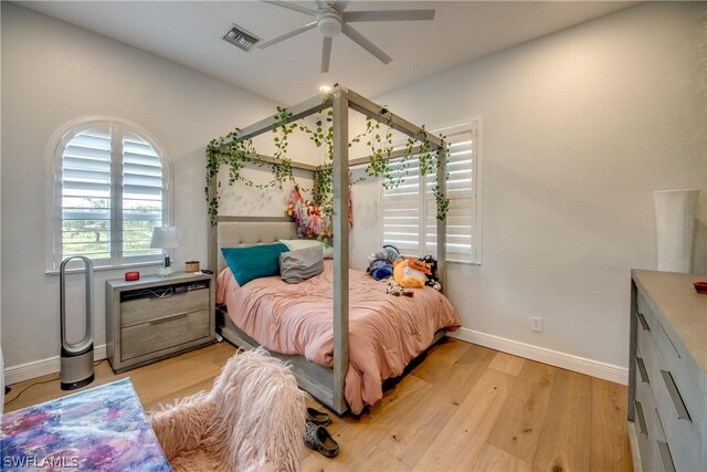 bedroom with light hardwood / wood-style flooring and ceiling fan