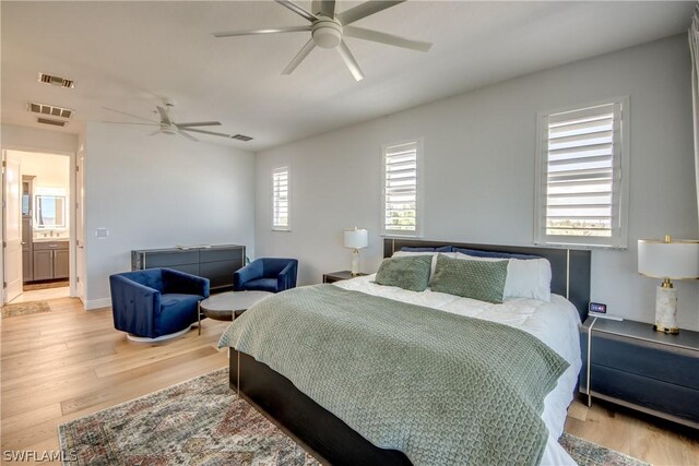 bedroom with ceiling fan, hardwood / wood-style flooring, and multiple windows