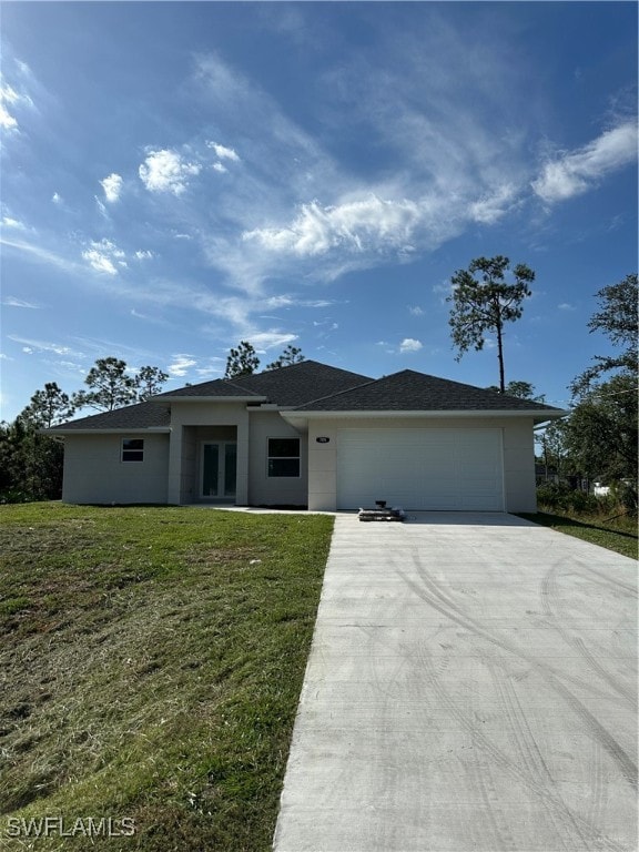 view of front of property featuring a garage and a front yard