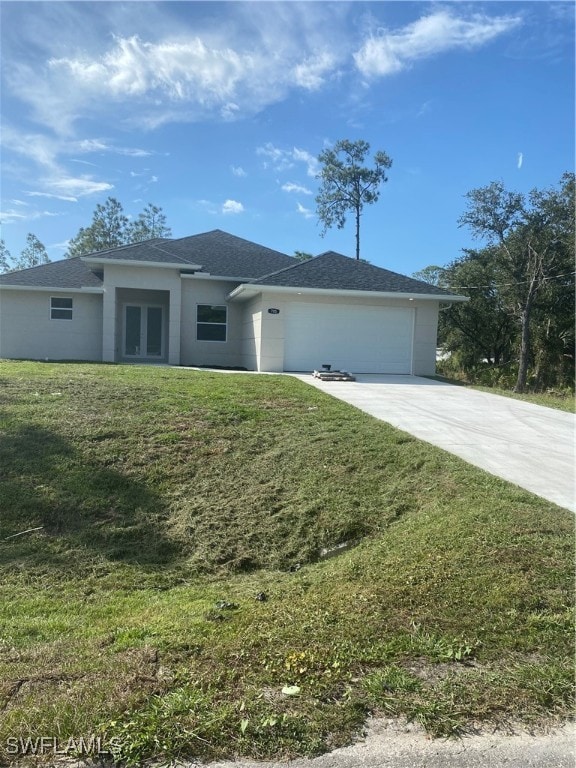 view of front of home with a garage and a front lawn