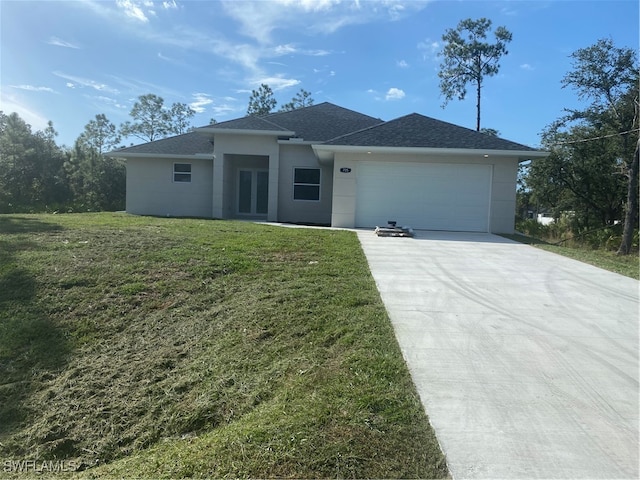 view of front of property featuring a front yard and a garage