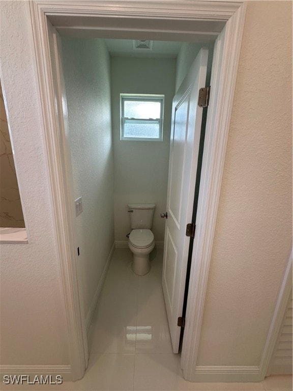 bathroom featuring tile patterned flooring and toilet