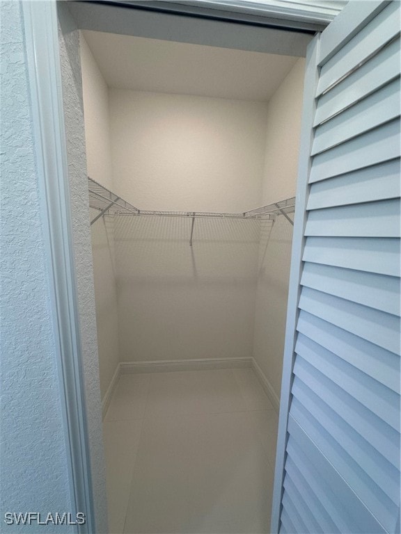 spacious closet with tile patterned floors