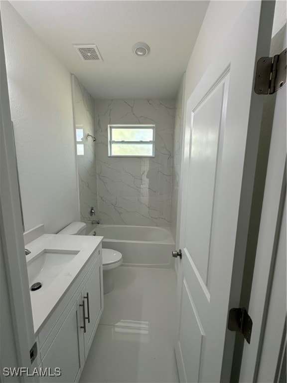 full bathroom featuring vanity, toilet, and tiled shower / bath