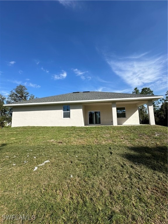 back of house with a yard