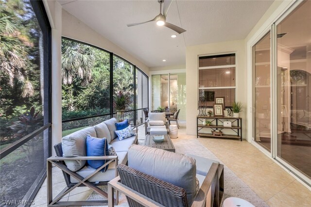 sunroom featuring ceiling fan