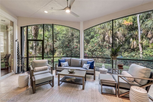 sunroom featuring ceiling fan and a wealth of natural light