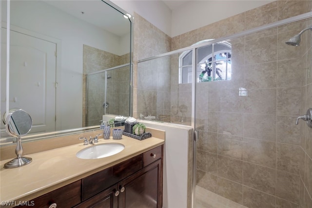 full bath with a shower stall and vanity