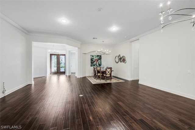 living room with a chandelier, french doors, crown molding, and dark wood-style floors