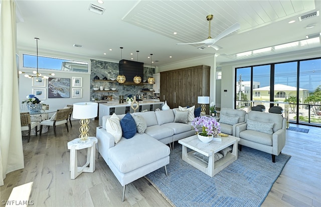 living room featuring plenty of natural light, light wood-type flooring, and ceiling fan