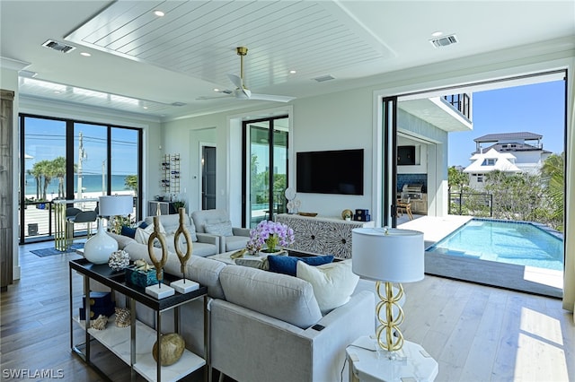 living room featuring ceiling fan and hardwood / wood-style flooring