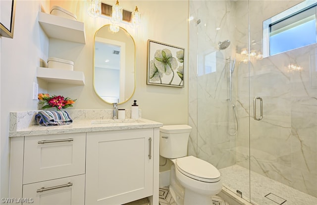 bathroom featuring walk in shower, vanity, and toilet