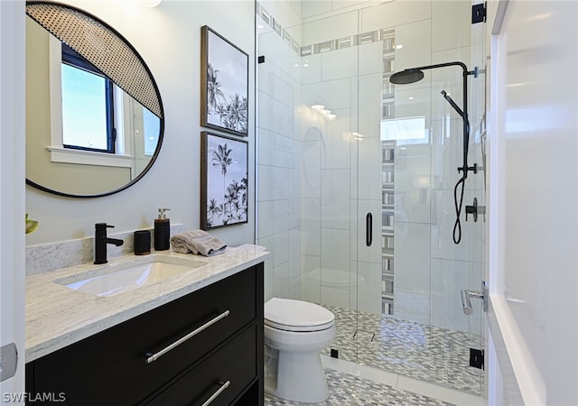 bathroom featuring a shower with door, a wealth of natural light, and toilet