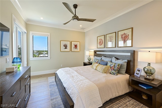 bedroom featuring ceiling fan, ornamental molding, and light hardwood / wood-style floors