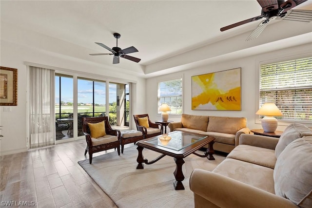 living room with ceiling fan and light hardwood / wood-style floors