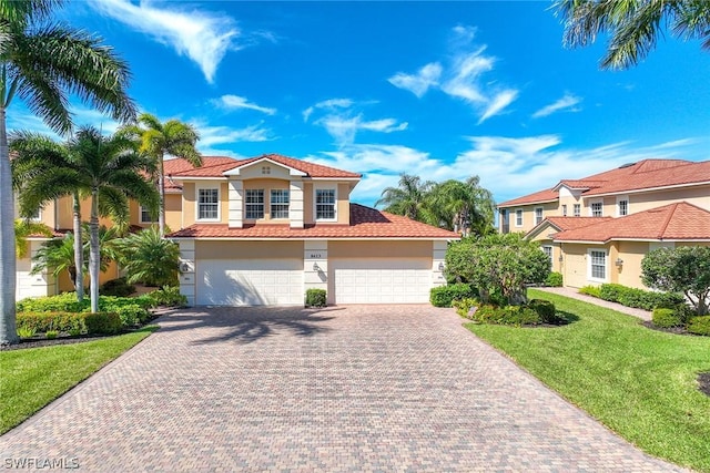 mediterranean / spanish-style house with a front lawn and a garage