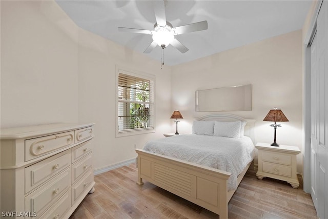 bedroom with a closet, ceiling fan, and light hardwood / wood-style flooring