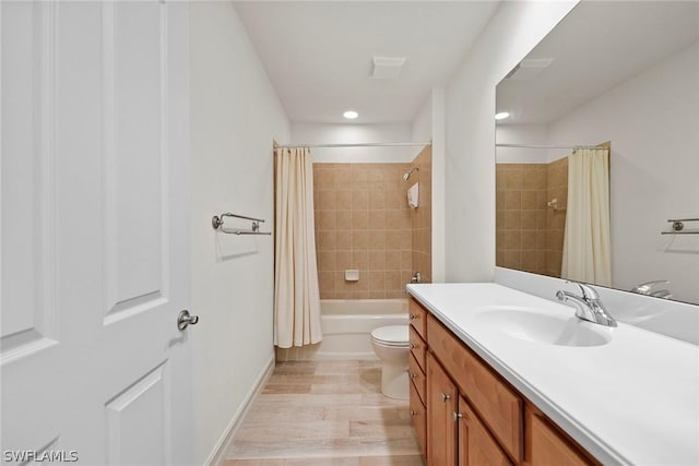 full bathroom featuring shower / bath combo, vanity, hardwood / wood-style flooring, and toilet