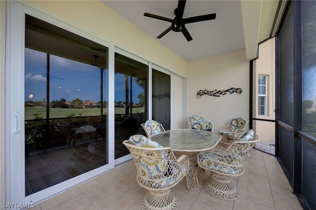 sunroom featuring ceiling fan