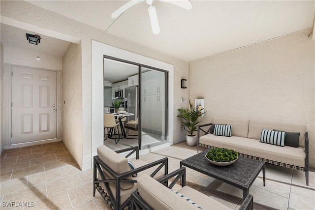 view of patio with an outdoor living space and ceiling fan