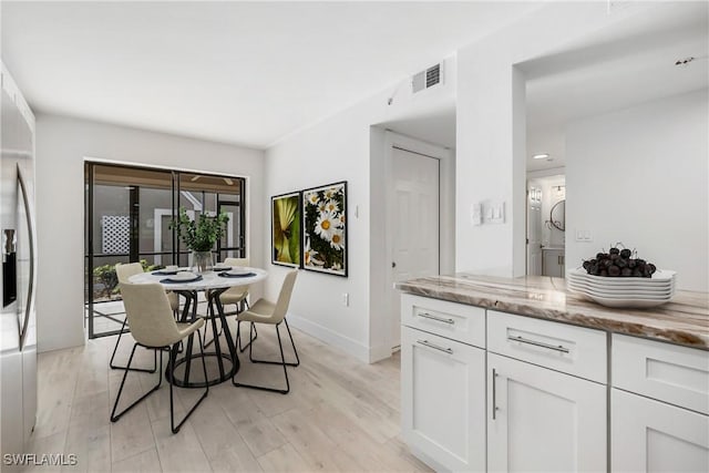 dining area with light hardwood / wood-style floors