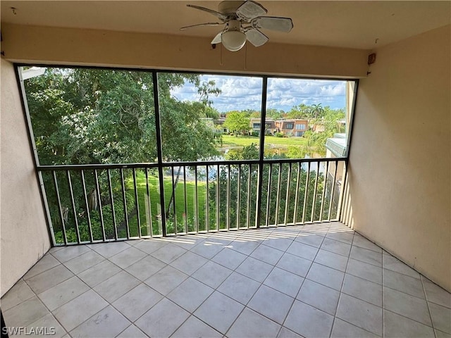 unfurnished sunroom with ceiling fan