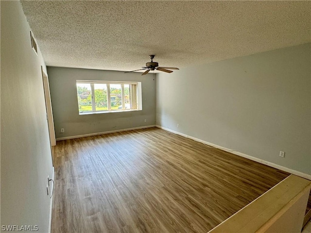 spare room featuring a textured ceiling, hardwood / wood-style floors, and ceiling fan