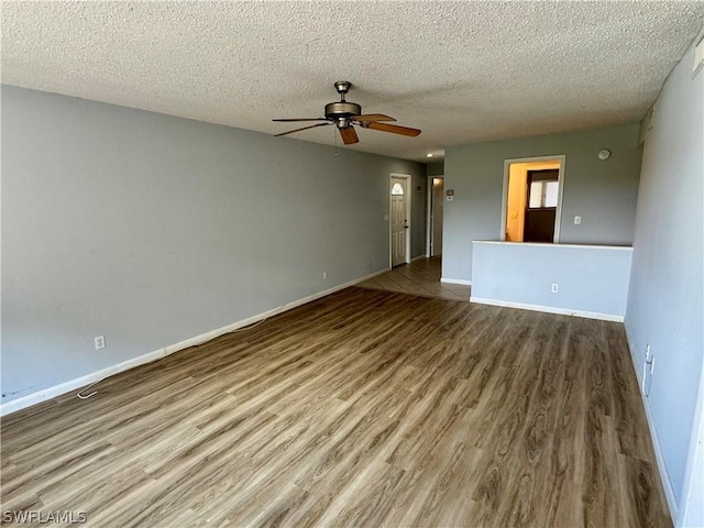 unfurnished living room with wood-type flooring, a textured ceiling, and ceiling fan