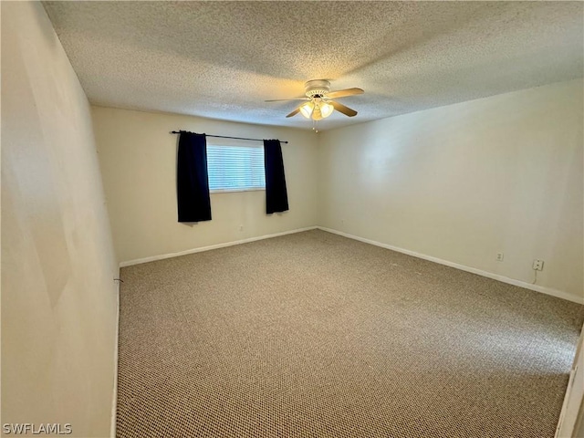 carpeted spare room with a textured ceiling and ceiling fan