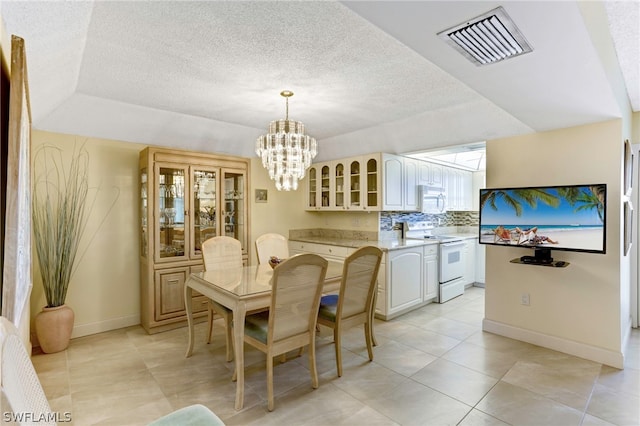 tiled dining space with an inviting chandelier