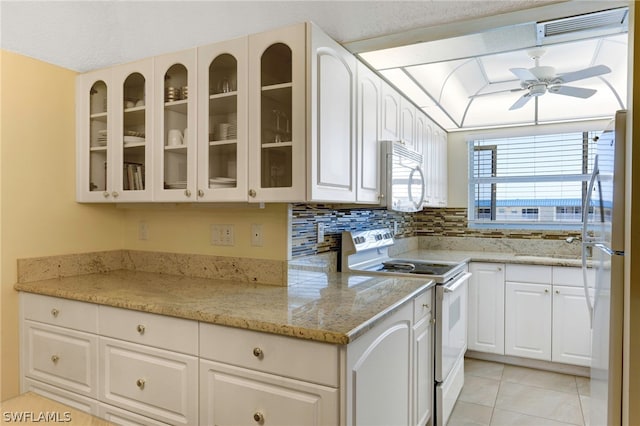 kitchen featuring ceiling fan, tasteful backsplash, light tile patterned flooring, white appliances, and white cabinets