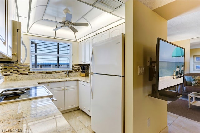 kitchen with white cabinetry, backsplash, white appliances, light tile patterned flooring, and sink