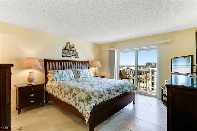 tiled bedroom featuring a textured ceiling and access to outside