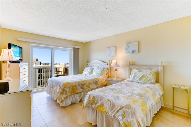 tiled bedroom featuring access to exterior and a textured ceiling