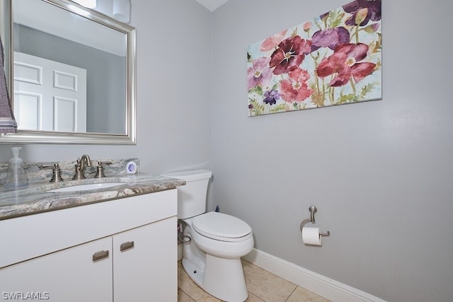 bathroom featuring tile patterned floors, vanity, and toilet