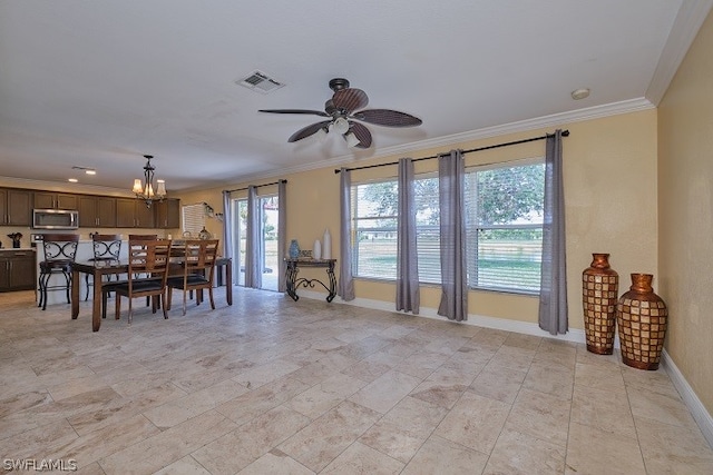 dining area with crown molding and ceiling fan