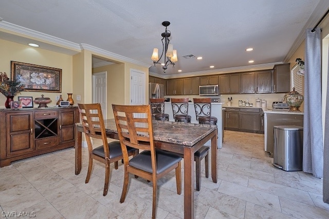 dining space featuring ornamental molding and an inviting chandelier