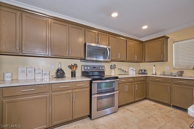 kitchen with light stone countertops, ornamental molding, and stainless steel appliances