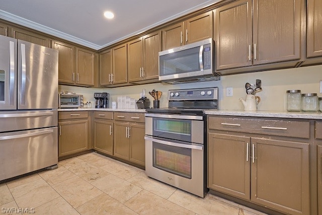 kitchen with crown molding, appliances with stainless steel finishes, and light stone countertops