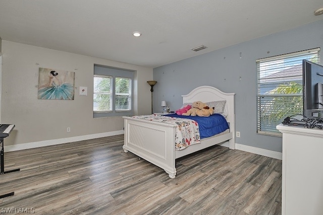 bedroom featuring dark hardwood / wood-style flooring