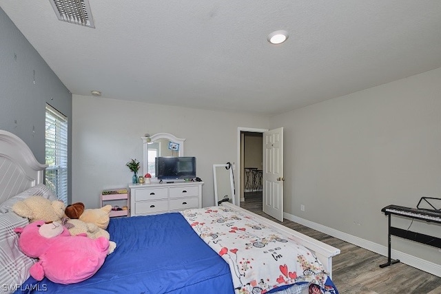 bedroom with dark hardwood / wood-style floors