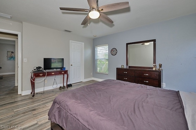 bedroom with ceiling fan and light hardwood / wood-style floors