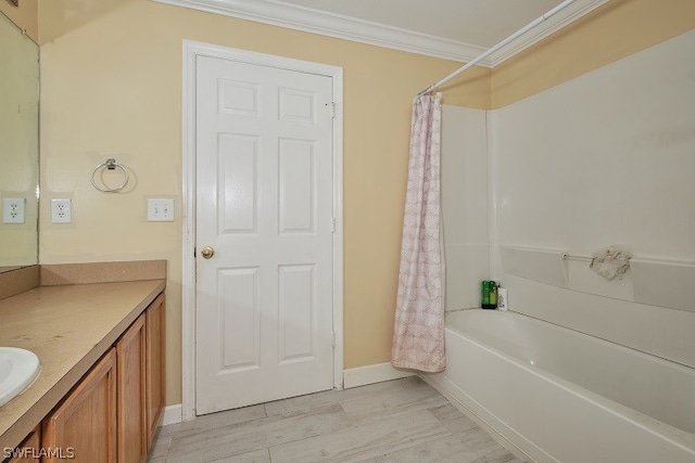 bathroom with vanity, hardwood / wood-style flooring, ornamental molding, and shower / bath combination with curtain