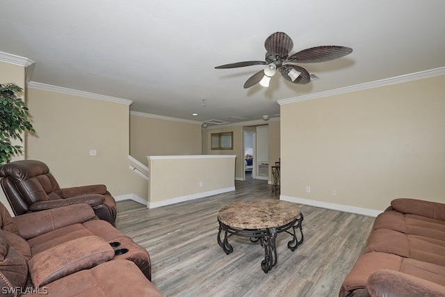 living room featuring ornamental molding, light hardwood / wood-style floors, and ceiling fan