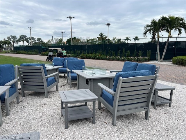 view of patio featuring an outdoor living space with a fire pit