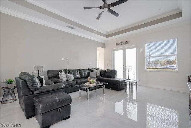 living room with french doors, a raised ceiling, ceiling fan, and ornamental molding